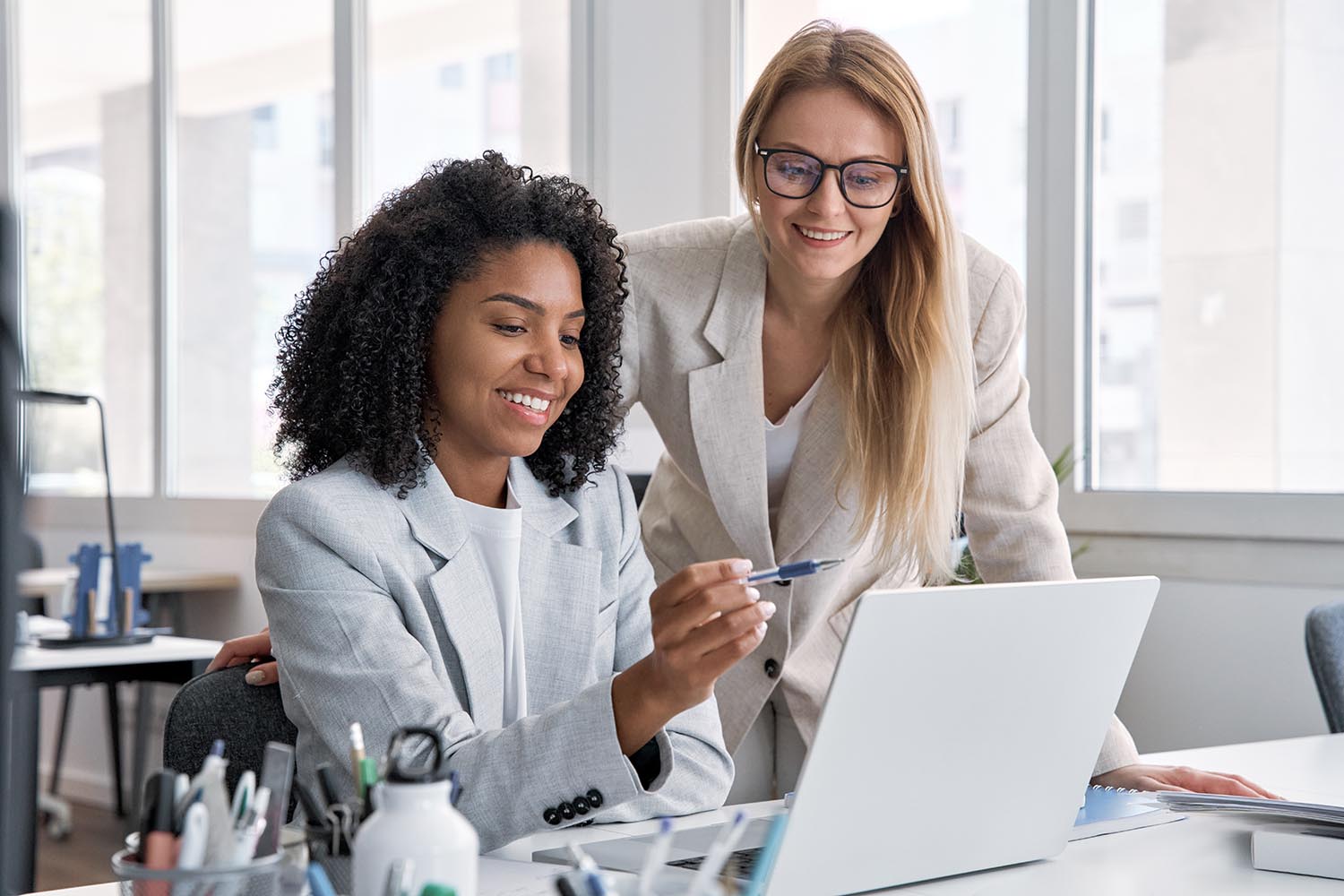 Two women reviewing useful people-first content together